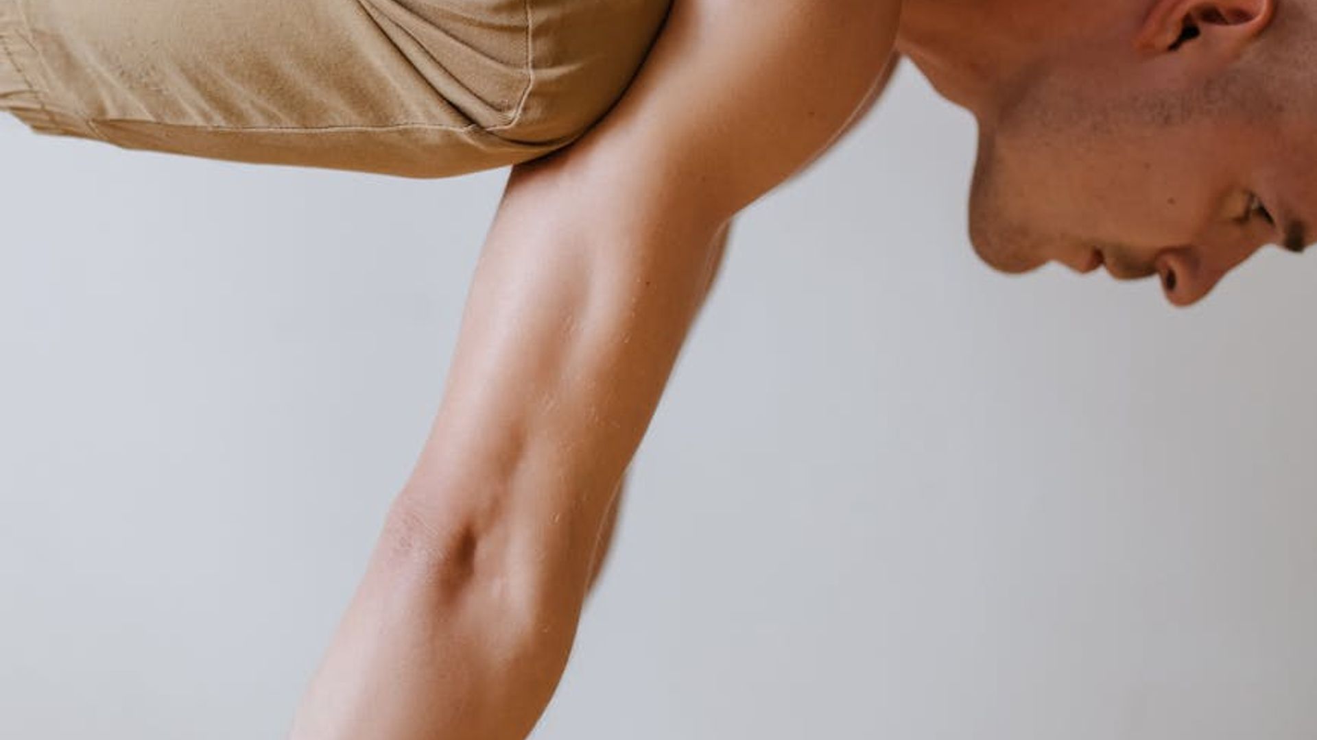 Active woman practicing core stabilization exercises in a dark studio.