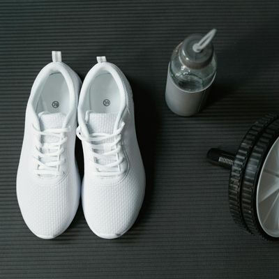 Close up of sports shoes and a bottle of water.