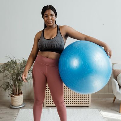 Hands of a woman holding a small exercise ball.