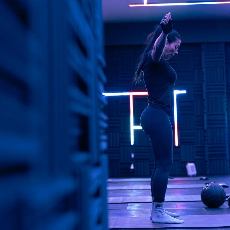 Minimalist fitness studio with neon lighting and mats.